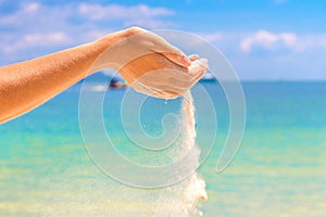 Sand falling through woman hands