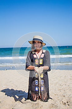 Sand falling from the woman`s hand.