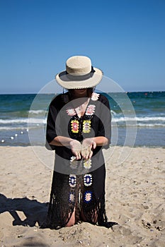 Sand falling from the woman`s hand.