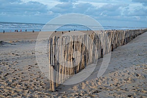 Sand fence on wide windy beach of North sea near Zandvoort in Netherlands