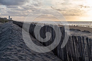 Sand fence on wide windy beach of North sea near Zandvoort in Netherlands