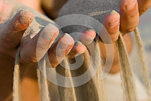 Sand flowing through fingers