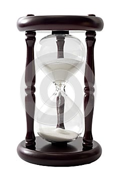 Sand flowing in transparent hourglass used to measure the passing of time, isolated on white background with clipping path cutout