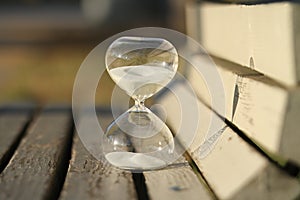 Sand-glass. Modern hourglass on a bench in a park