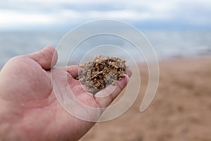 Sand in hand on the lake