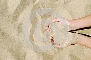 Sand in hands of girl. Hand strew sand