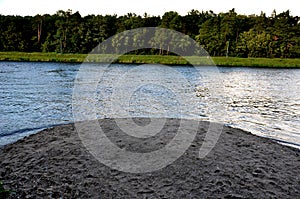 sand hill on the bank of the river, sediments tossed by the waves.