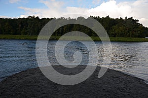 sand hill on the bank of the river, sediments tossed by the waves.