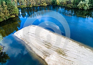 Sand island in a lake from a sand quarry, aerial view