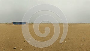 Sand land and the city in far distance at cloudy day loop