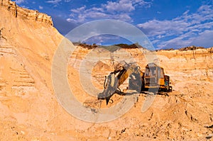 Sand mining concept. Old quarry sand excavator with heavy machinery. Construction industry. Old rusty bulldozer machine at break