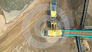 Sand mining industry. Bulldozer machine. Crawler bulldozer moving at sand mine. Mining machinery working at sand quarry. Drone