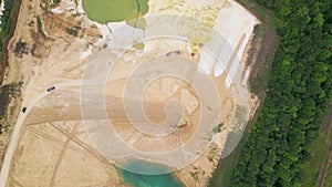 Sand Mining Plant with Machinery on White Sand and Bue Water Lake