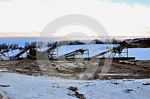 Sand mining in winter conditions in an industrial quarry.