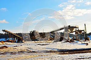 Sand mining in winter conditions in an industrial quarry