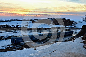 Sand mining in winter conditions in an industrial quarry.