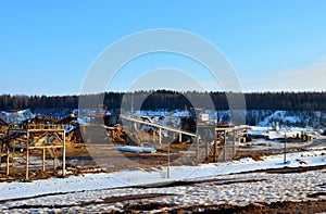 Sand mining in winter conditions in an industrial quarry. Conveyor Belt in mining quarry