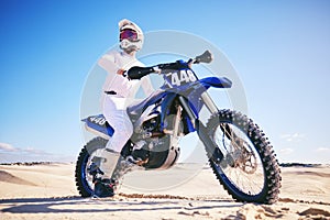 Sand, motor sports and man drive with motorbike for adrenaline, adventure and freedom in desert. Action, extreme sport