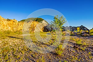 Sand, mountain cliffs and blue sky photo