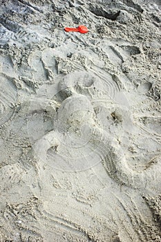 Sand octopus sculpture on beach