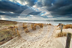 Sand path with fence to North sea beach