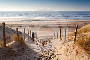 Sand path to North sea at sunset