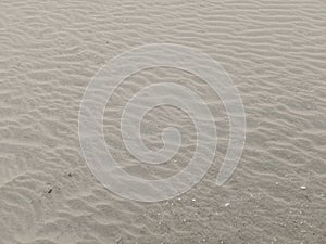Sand with the pattern of the wind, creating a wave like texture photo