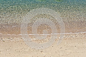 The sand and pebbles along the beach.