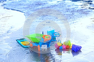 Sand playing toy ,shovel,dumpping wagon,water pot on beach front in summer vacation concept with copy space