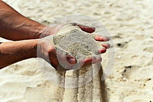 Sand poured down from hands