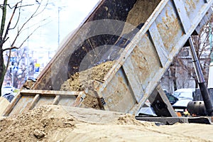 Sand is poured out of the truck body.