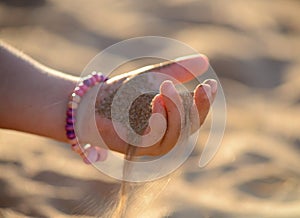 Sand pours out of the child hand photo