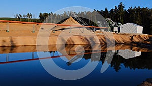 Sand production. sand extraction on the shore of the pond in a sand quarry