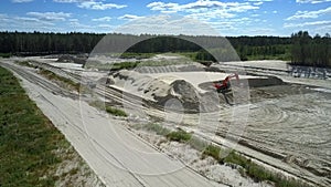 Sand quarry with excavator and truck ners lake bird eye view