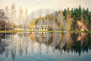 Sand rock with trees by the lake with reflection