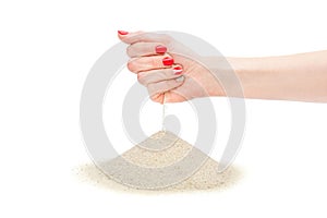 Sand running through female\'s hand on heap. Isolated on white. Time running out concept