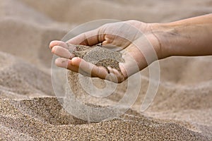 Sand running through fingers