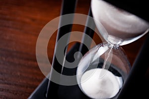 Sand running through an hour glass