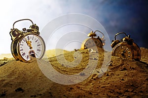 Sand running out of an alarm clock, other watches sink into the photo