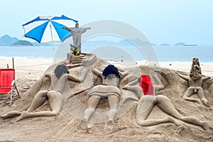 Sand sculpture sunbathe on the beach of Copacabana