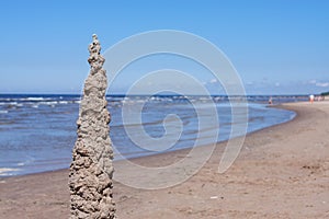 Sand sculptures figures on the beach in sunny day