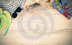 Sand and shells and hat on the wooden floor, summer concept