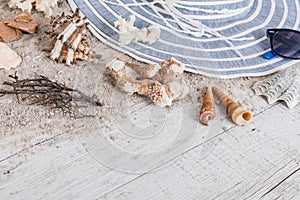 Sand and shells and hat on the wooden floor, summer concept