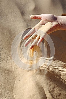 Sand slipping through fingers
