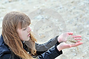 Sand slips through fingers