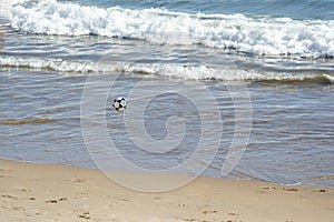 Sand soccer ball flying in the sands of the beach of Ondina