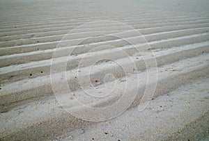 Sand steps left by the tide.