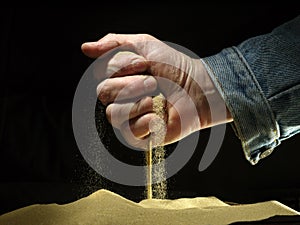 Sand strewed from a fist