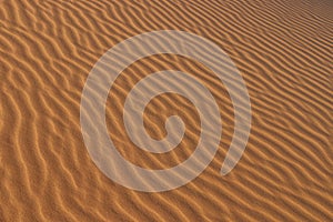 Sand texture - background of desert sand dunes. Beautiful structures of sandy dunes. sand with wave from wind in desert