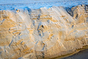 Sand texture of the colored sand cliffs on beach